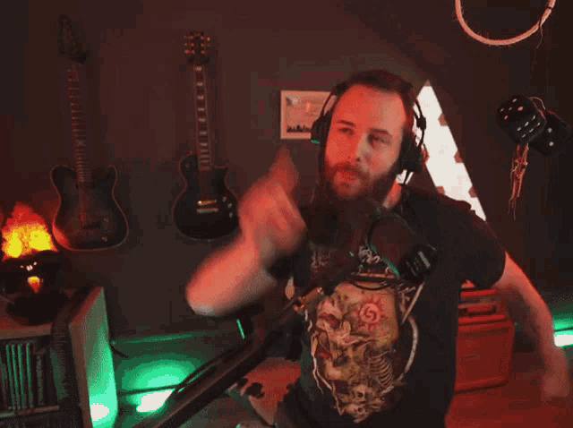 a man with a beard is wearing headphones and a shirt that says ' skeletons ' on it