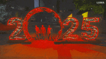 a group of people standing in front of a sign that says 2022