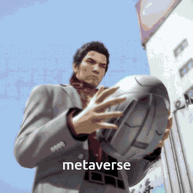 a man in a suit is holding a helmet with the word metaverse written on it