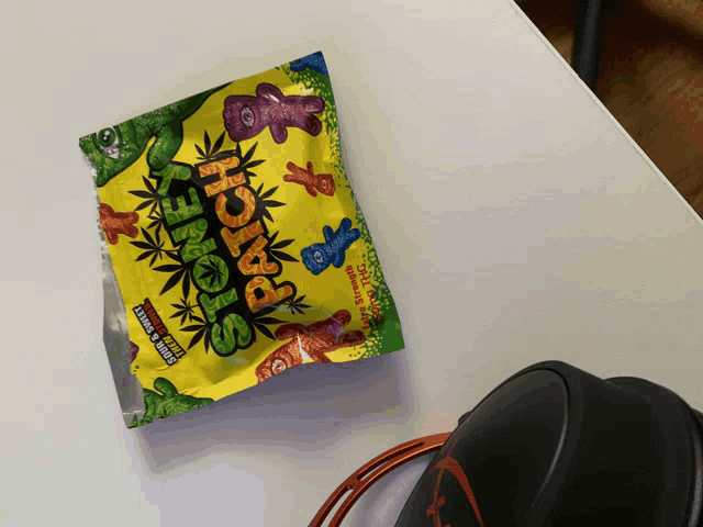 a bag of stone patches sits on a table next to headphones