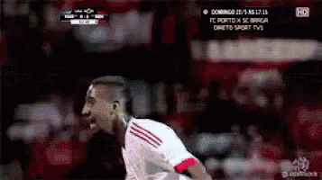 a soccer player in a white and red jersey is playing on a tv screen