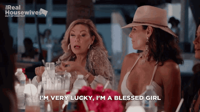 two women are sitting at a table and one of them is saying i 'm very lucky