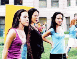 a group of young women standing in a field