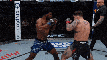 two men are fighting in a boxing ring with a crypto.com banner in the background
