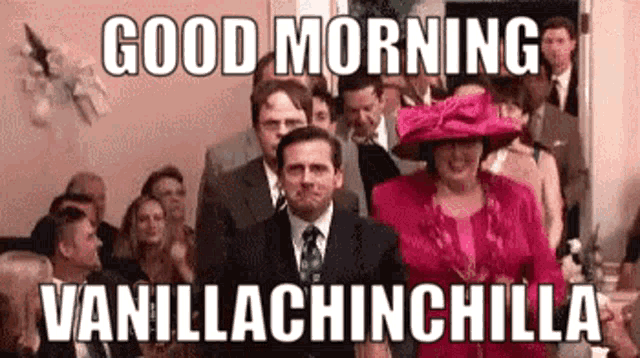 a man in a suit and tie is standing in front of a crowd of people and says `` good morning vanillachinchilla '' .