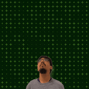 a man stands in front of a green background with the number 3 + 1