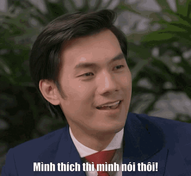 a man in a suit and tie says minh thích thì minh nói thôi