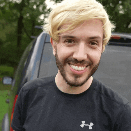 a man with blonde hair and a beard wearing a black under armour shirt