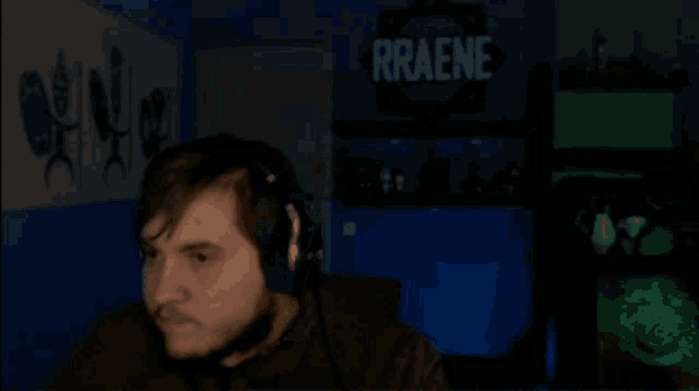 a man in a dark room with a sign that says rraene