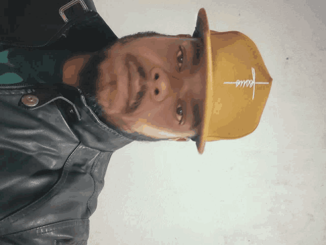 a man wearing a yellow hat that says jesus