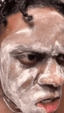 a close up of a person 's face covered in white soap