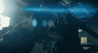 a man and a woman are fighting in a dark room with blue light behind them