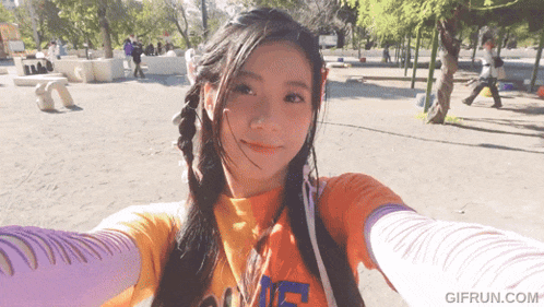 a girl taking a selfie with a gif run.com watermark