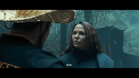 a man in a straw hat is talking to a woman who is wearing a jacket that says dick on it