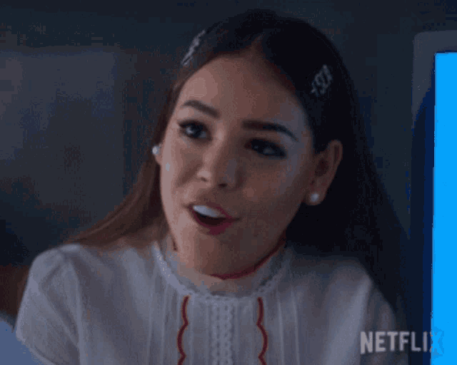 a close up of a woman 's face with a netflix logo behind her