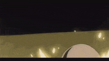 a close up of a cartoon character 's head with a fireball coming out of it in the dark .