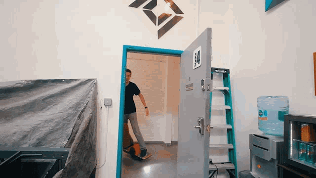 a man standing in a doorway with a sign on the door that says ' emergency exit '