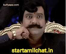 a man with a mustache is sitting in a chair with his hand on his chin