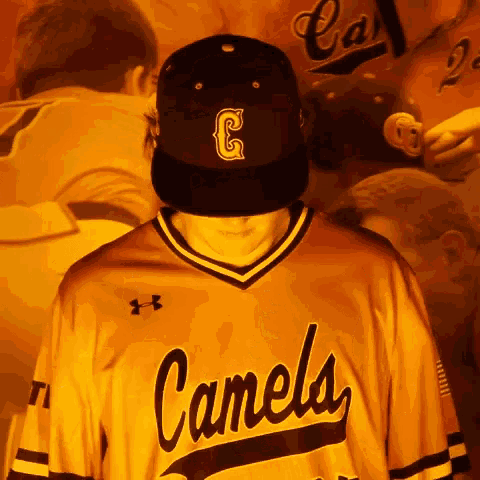 a man wearing a camels jersey and hat