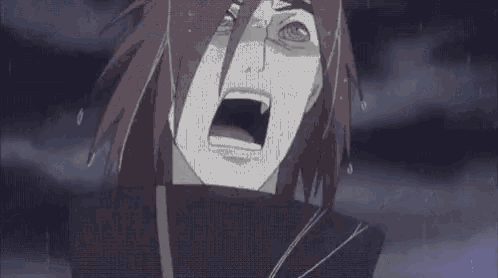 a close up of a person 's face with their mouth open and tears coming out of it .