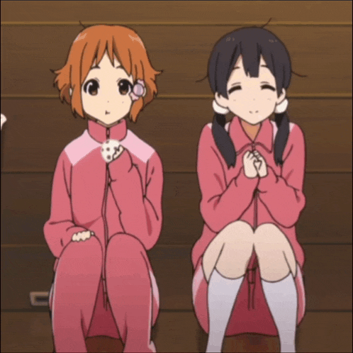 two anime girls are sitting next to each other with their knees crossed