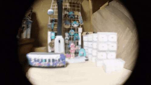 a blurred image of a room with a shelf full of toys and boxes