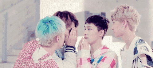 a group of young men are standing next to each other and making funny faces .