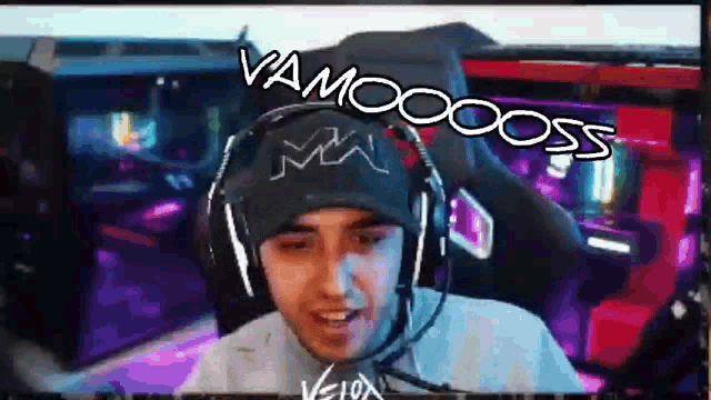 a man wearing headphones and a hat says vamoss on the screen
