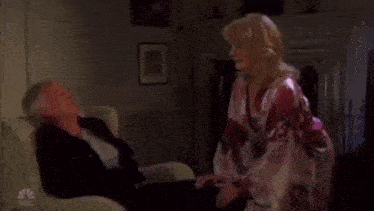 a man and a woman are sitting in a living room .