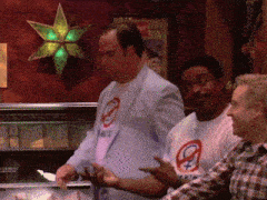 a man wearing a t-shirt that says yes is standing next to another man