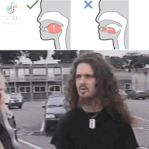a man with long hair and a beard is standing in a parking lot next to a diagram of his mouth .
