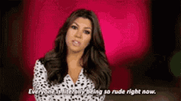 a woman is standing in front of a pink wall and saying `` everyone is literally being so rude right now . ''