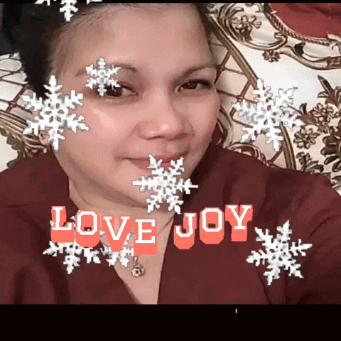 a woman with snowflakes on her face and the words love joy in red