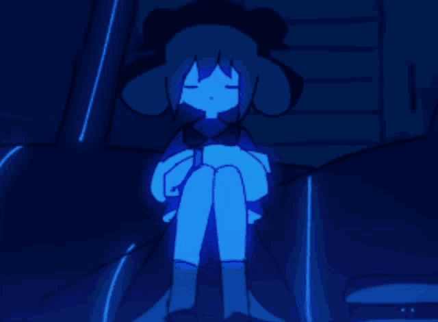 a person standing in a dark room with a blue background