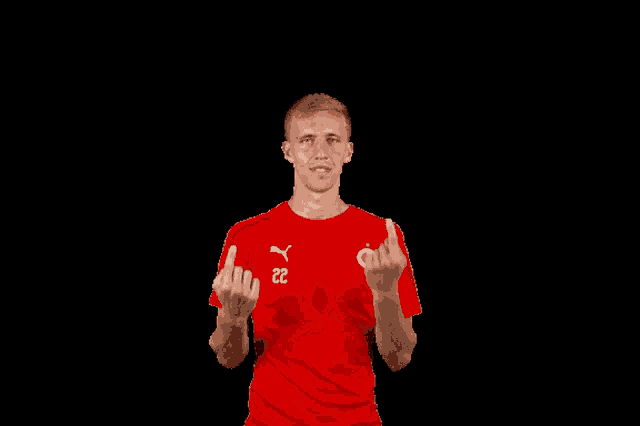 a man in a red shirt with the number 22 on his chest