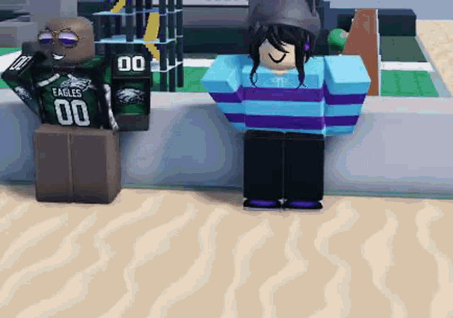 two roblox characters are standing next to each other on a beach . one of the characters is wearing a green eagles jersey .
