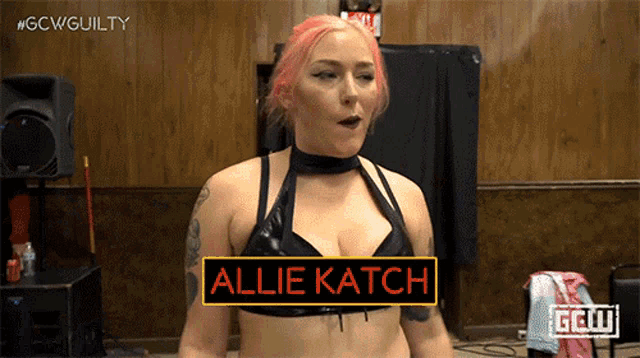 a woman in a black bra with the name allie katch on her chest