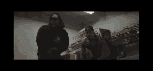 two men are standing next to each other in a room .
