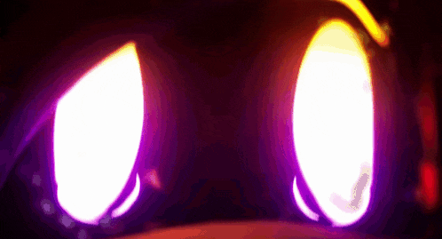 a close up of a pair of glowing eyes in the dark