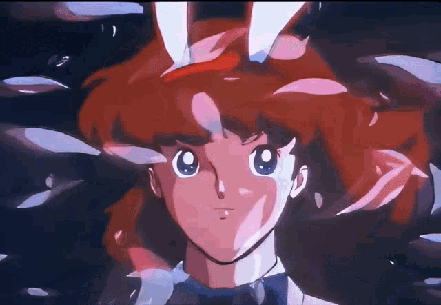 a girl with red hair and blue eyes looks at the camera