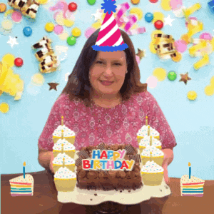 a woman wearing a party hat holds a birthday cake