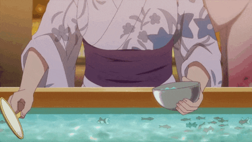 a woman in a kimono is holding a bowl of fish