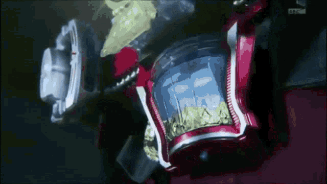 a close up of a red object with a blue container inside of it