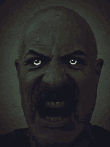 a man with a mustache is making a very angry face
