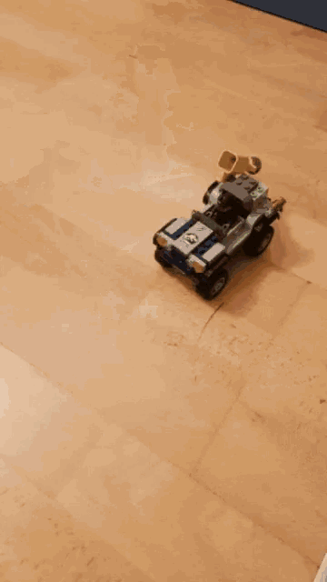 a toy hulk is standing next to a toy jeep