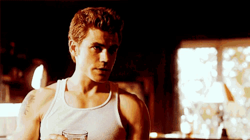 a man in a white tank top has a tattoo on his arm that says ' amelia '