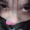a close up of a person 's face with their tongue hanging out .