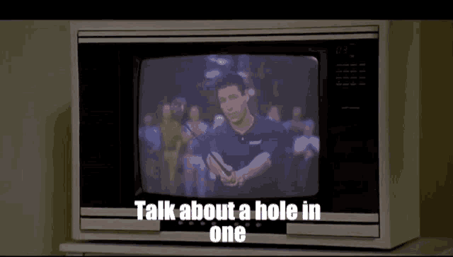 a tv screen shows a man holding a golf club and the words talk about a hole in one