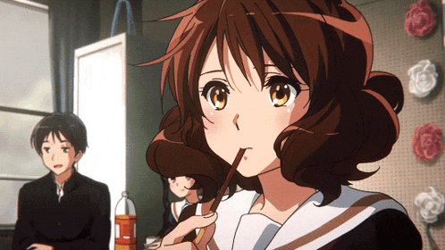 a girl in a school uniform is drinking from a straw while a boy looks on