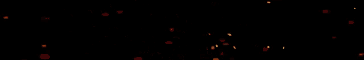 a lot of sparks are flying in the air on a black background